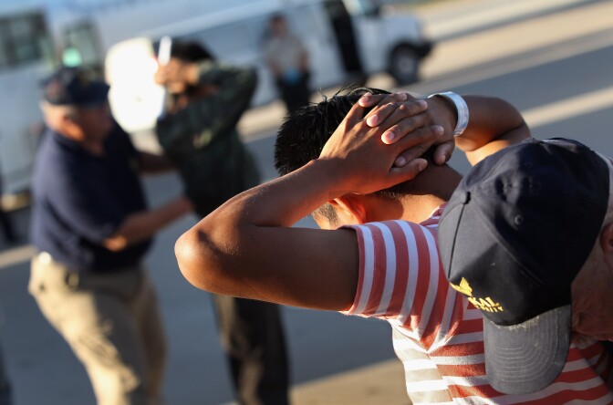 MESA, AZ - JUNE 24:  Undocumented Guatemalan immigrants are body searched before boarding a deportation flight to Guatemala City, Guatemala at Phoenix-Mesa Gateway Airport on June 24, 2011 in Mesa, Arizona. The U.S. Immigration and Customs Enforcement agency, ICE, repatriates thousands of undocumented Guatemalans monthly, many of whom are caught in the controversial "Secure Communities" data-sharing program which puts local police on the frontlines of national immigration enforcement. ICE recently announced a set of adjustments to the federal program after many local communities and some states, including New York, insisted on opting out, saying immigrants were being deported for minor offenses such as traffic violations. Guatemala ranks only second to Mexico in the number of illegal immigrants deported from the United States.  (Photo by John Moore/Getty Images)