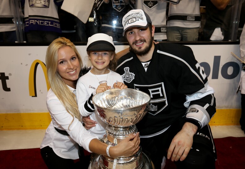 LOS ANGELES, CA - JUNE 13:  Slava Voynov #26 of the Los Angeles Kings and family celebrate after the Kings win the Stanley Cup after defeating the Rangers 3-2 in double overtime during Game Five of the 2014 Stanley Cup Final at Staples Center on June 13, 2014 in Los Angeles, California.  (Photo by Bruce Bennett/Getty Images) *** Local Caption *** Jake Muzzin