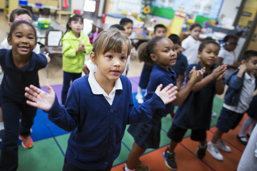 Kindergarteners Kameera Turrentine, left, Daisy Mayer-Glenn, center, and Lena Winston sing a song with their class at Willard Elementary School in Pasadena, two weeks into the school year, on Wednesday morning, Aug. 31, 2016.