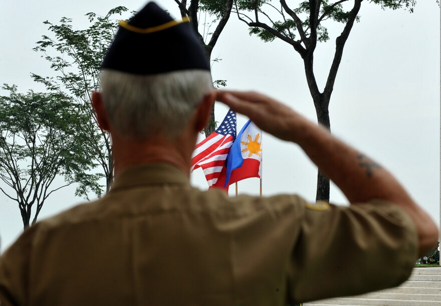 A retired American soldier salutes to the colors during Veterans Day celebration at the American Cemetery in Manila on November 11, 2010. The US pays tribute on Veterans Day to the men and women who have worn the uniform of the United State Armed Forces.  AFP PHOTO / JAY DIRECTO (Photo credit should read JAY DIRECTO/AFP/Getty Images)