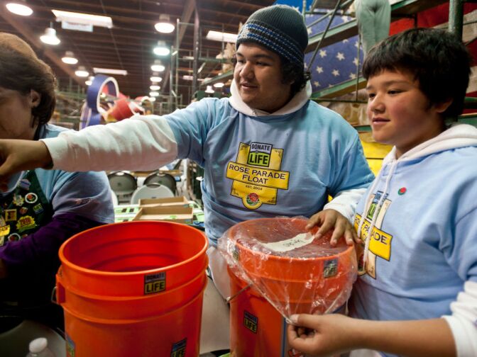 Arturo and Ernesto Bravo Chavez work as volunteers on the Donate Life parade float. Their family, along with the Barajas family will participate in the parade on New Year's Day together.