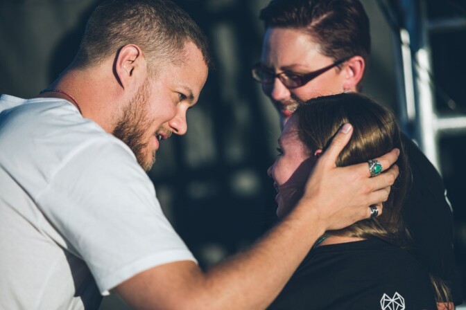 Dan Reynolds greets Savannah and her mother, Heather Kester, after Savannah's speech at the 2017 LoveLoud Festival in Orem, Utah.