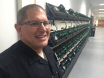 LAPD Sgt. Fabian Ospina stands next to the docking stations where Central Division officers upload hours of video from body worn cameras daily.