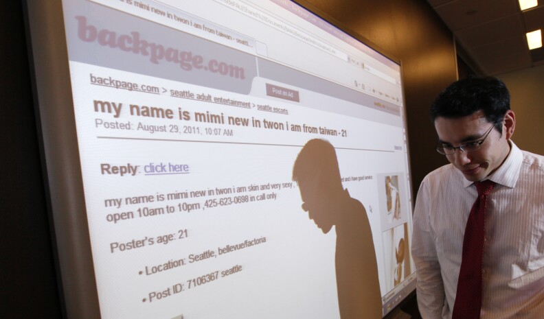 File: Washington state assistant attorney general Jonathan Mark walks past a display of a Backpage.com ad following a news conference about action being taken against the adult services site Wednesday, Aug. 31, 2011, in Seattle.