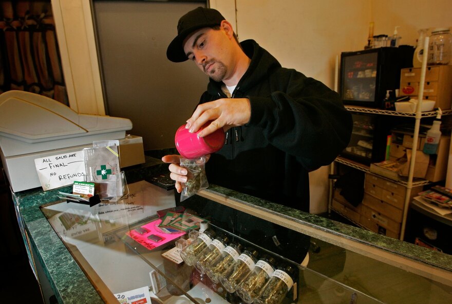File: An employee at a medical marijuana dispensary.