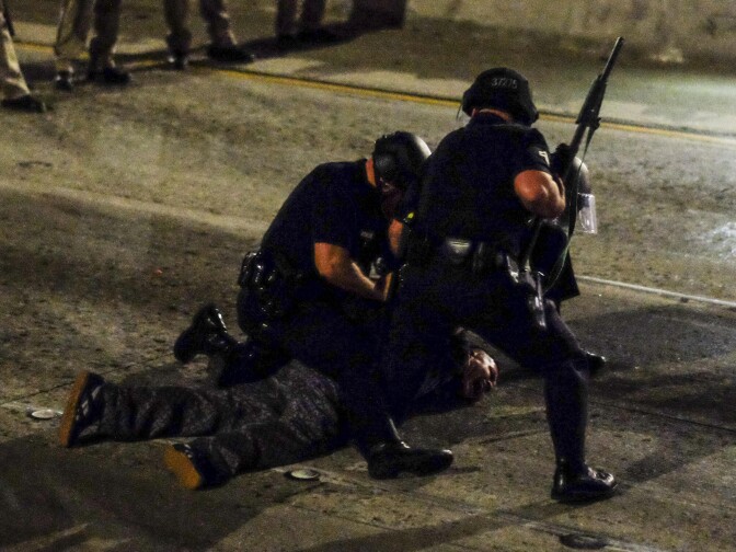 Police arrest a demonstrator after people shut down the 101 Freeway, a major thoroughfare in the city, following a rally to protest a day after President-elect Donald Trump's election victory in Los Angeles, California, late on November 9, 2016.
Protesters burned a giant orange-haired head of Donald Trump in effigy, lit fires ins the streets and blocked traffic lanes late on November 9 as rage over the billionaire's election victory spilled onto the streets of US cities. From New York to Los Angeles, thousands of people in around 10 cities rallied against the president-elect a day after his stunning win, some carrying signs declaiming "Not our President" and "Love trumps hate." / AFP / RINGO CHIU        (Photo credit should read RINGO CHIU/AFP/Getty Images)