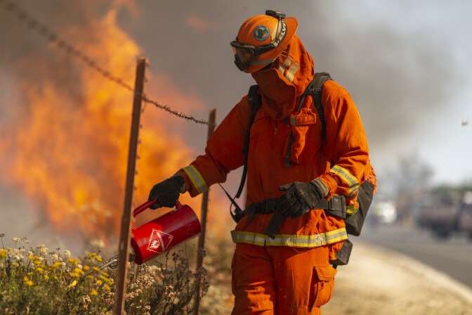 SIMI VALLEY, CA - OCTOBER 30: An inmate firefighter from Oak Glen Conservation Camp near Yucaipa, California sets a backfire during the Easy Fire on October 30, 2019 near Simi Valley, California. The National Weather Service issued a rare extreme red flag warning for Southern California for gusts that could be the strongest in more than a decade, exceeding 80 mph, as the fast-moving brush fire threatens the Ronald Reagan Presidential Library and nearby residential neighborhoods. (Photo by David McNew/Getty Images)