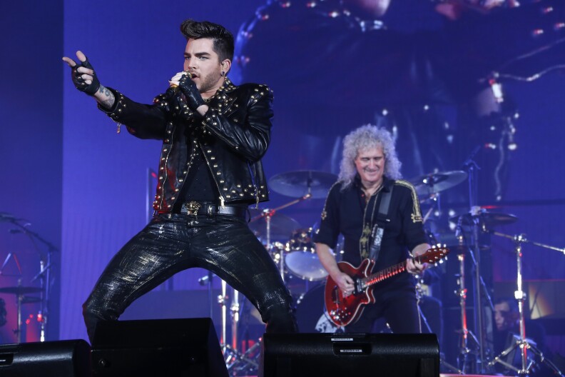 American singer Adam Lambert (L) performs with Guitarist Brian May (R) of the British rock band Queen, at the Zenith arena in Paris, on January 26, 2015. AFP PHOTO / THOMAS SAMSON        (Photo credit should read THOMAS SAMSON/AFP/Getty Images)
