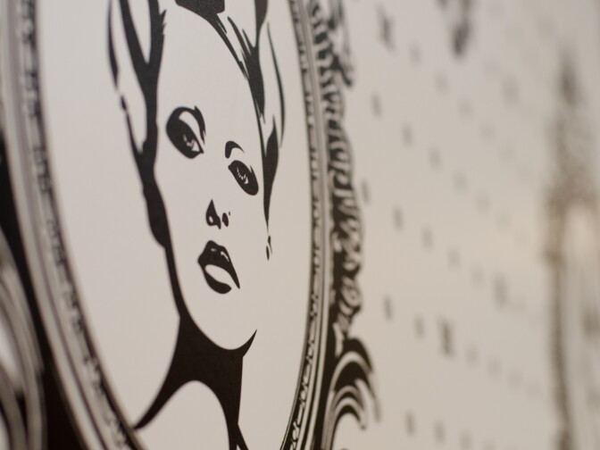 The design of a woman's face in a mirror is repeated on the wall that lines the wash station at Salon Meritage in Seal Beach, Calif., Thursday, November 15, 2012. The black and white design is one of strength and tranquility.