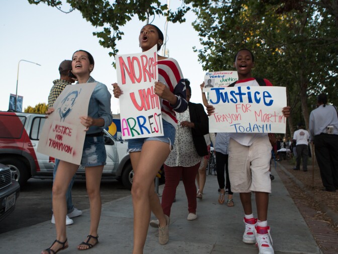Activists in South L.A. plan to monitor an area around Crenshaw Boulevard Tuesday night after some protesters caused some property damage Monday night. (Photo: Protestors march around L.A.'s Leimert Park in support of Trayvon Martin on July 15th, 2013).