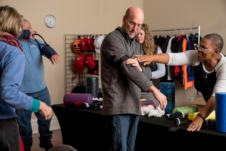 Stan Schloesser, center, practices using a tourniquet, with assistance from project manager Erica Jones during the November "Stop the Bleed" class. If you can stop the bleed, you can save a life," students learn.