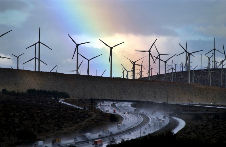 A rainbow forms behind giant windmills near rain-soaked Interstate 10 as an El Nino-influenced storm passes over the state on December 17, 2002 near Palm Springs, California.