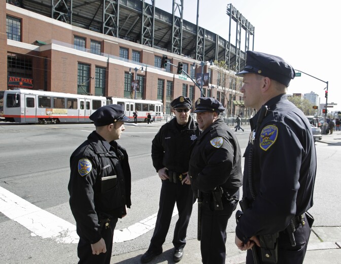 San Francisco police officers gather outside AT&T Park before the San Francisco Giants' baseball game against the Los Angeles Dodgers in San Francisco, Monday, April, 11, 2011. The Giants beefed up security for a three-game series against the Dodgers less than two weeks after a fight at Dodger Stadium left a Giants fan in a medically induced coma. (AP Photo/Eric Risberg)