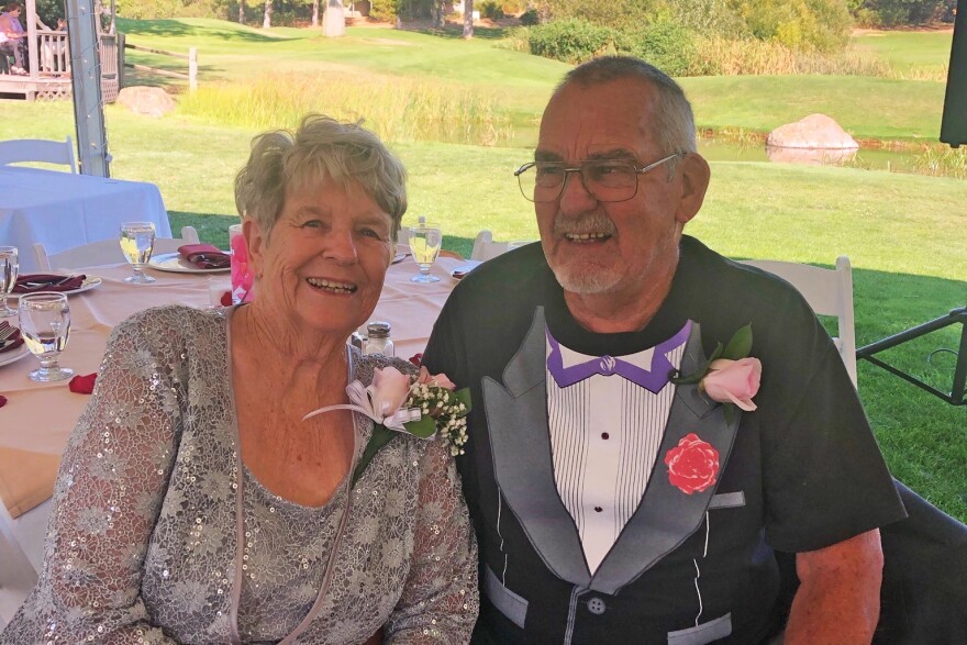 Two older adults smile for a photo