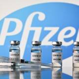 An illustration picture shows vials with Covid-19 Vaccine stickers attached and syringes with the logo of US pharmaceutical company Pfizer, on November 17, 2020. (Photo by JUSTIN TALLIS / AFP) (Photo by JUSTIN TALLIS/AFP via Getty Images)