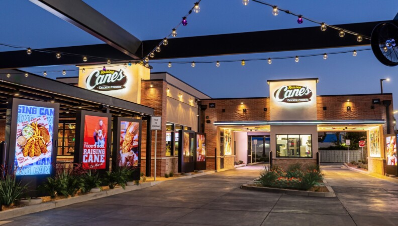 Establishing shot of a Raising Cane’s at night.