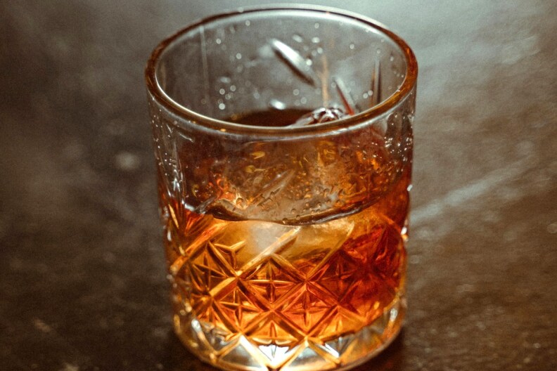 A close-up of a dark cocktail in a crystal glass.