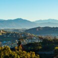 An image of foothills and houses in the San Gabriel Valley with a mountain range in the background.