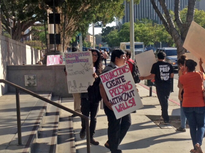 Protesters voice their opposition to an Echo Park gang injunction on Wednesday, Aug. 21, 2013.
