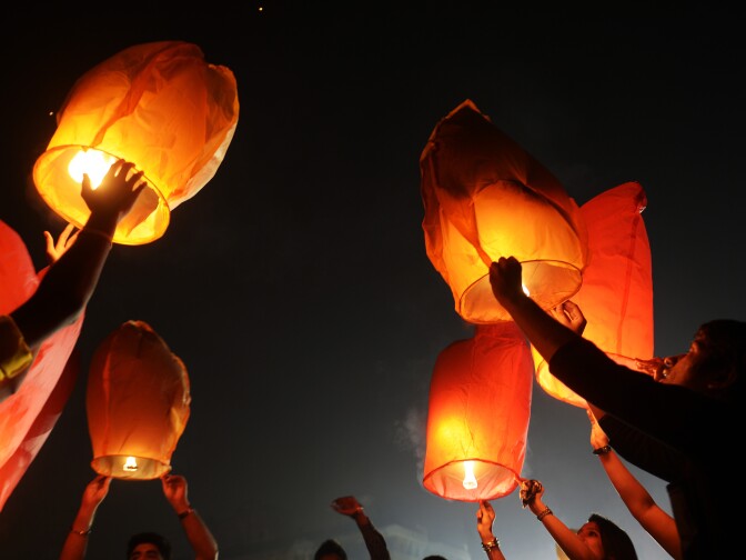 Indian volunteers of a social organization release sky lanterns to promote a peaceful and eco-friendly Diwali and create awareness against child labour in the fire cracker industry during a function in Kolkata on October 30, 2013. Diwali, the Festival of Lights, marks victory over evil and commemorates the time when Hindu god Lord Rama achieved victory over Ravana and returned to his kingdom Ayodhya. 