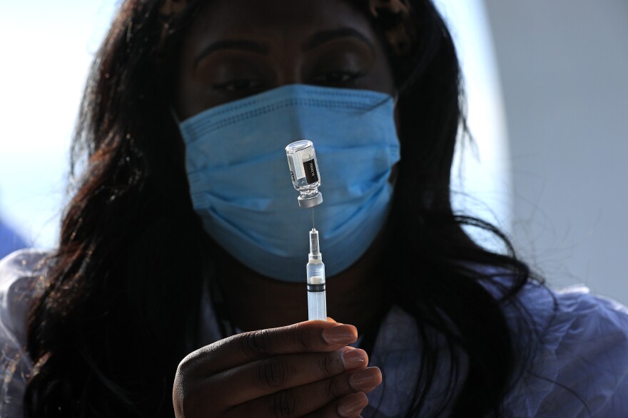 WASHINGTON, DC - MAY 06: DC Health Nurse Manager Ashley Hennigan fills a syringe with a dose of the Johnson & Johnson coronavirus vaccine during a walk-up clinic at the John F. Kennedy Center for the Performing Arts' outdoor Reach area on May 06, 2021 in Washington, DC. Hosted by the District of Columbia Health Department, the event also provided newly vaccinated people with a free beer courtesy of Solace Brewing Co. (Photo by Chip Somodevilla/Getty Images)