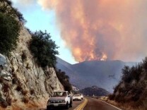 Flames from the Falls Fire in Riverside rise above a mountain on Aug. 5, 2013. 