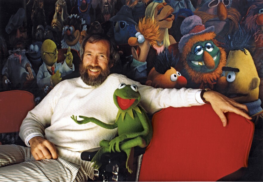 Jim Henson and his iconic creation, Kermit the Frog, in front of a mural by Coulter Watt. ©Disney/Muppets.