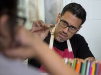 Nery Gabriel Lemus, art instructor at Armory Center for the Arts, works with young women of the Scott Camp Detention Center, Santa Clarita