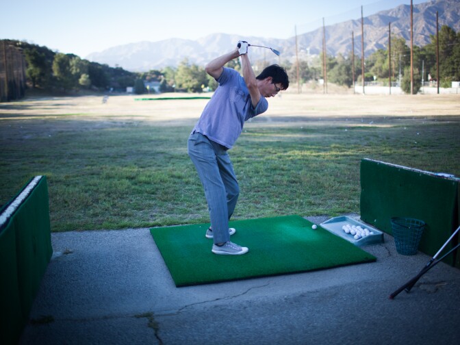 Hyung Kim drives golf balls at the Verdugo Hills Golf Course, the former location of the Tuna Camp site. 