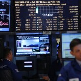 Traders work on the floor of The New York Stock Exchange on March 5, 2013 in New York City. Within the first few minutes of trading Tuesday, the Dow gained nearly 100 points, rising as high as 14,226.20, a new record high. 