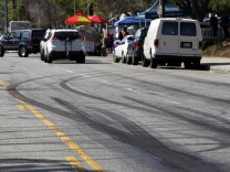 FILE - This Feb. 26, 2015 file photo shows skid marks visible along Plummer Street in the Chatsworth section of Los Angeles following an early-morning illegal street racing crash that killed two bystanders. Henry Gevorgyan, 21, suspected of driving the heavily-modified Mustang that crashed, turned himself in Saturday evening, Feb. 28, 2015. He has been booked on suspicion of murder and is being held on $2 million bail, jail records show. (AP Photo/Nick Ut, File)