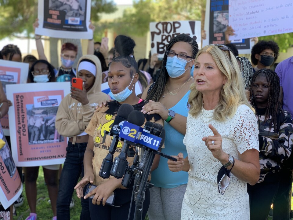Lisa Bloom, lawyer for the family speaks in front of press microphones at a press conference to remove LASD from Lancaster High. 