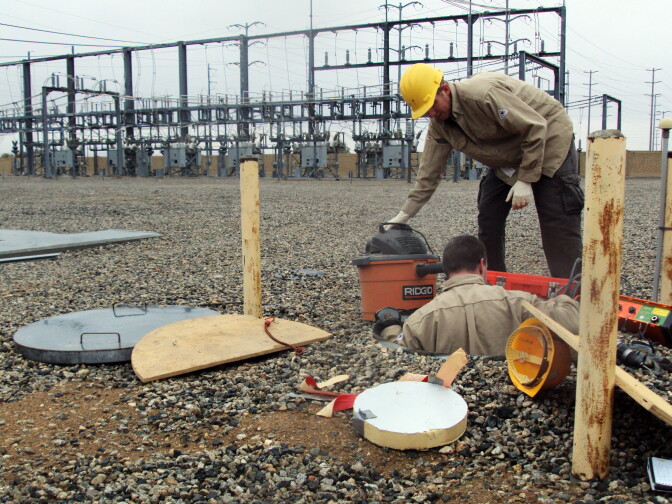 Russell Oliver (above) and Josh Sessoms are vacuuming sand from the vault that will soon hold a state of the art earthquake sensor. Once the new sensor is installed they will put more sand into a pipe around the sensor to insulate it from extreme temperatures.