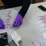 LOS ANGELES, CALIFORNIA - JANUARY 29: A firefighter paramedic prepares COVID-19 vaccination doses at a Los Angeles Fire Department (LAFD) fire station on January 29, 2021 in Los Angeles, California. The LAFD has recorded a ‘sharp decline’ in coronavirus cases after firefighters began receiving the vaccine shots on December 28. (Photo by Mario Tama/Getty Images)