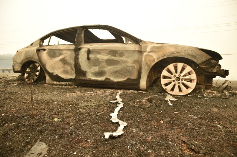 Melted metal flows from a burned out car abandoned on a highway during the Valley Fire in Middletown, California on September 13, 2015. The governor of California declared a state of emergency Sunday as raging wildfires spread in the northern part of the drought-ridden US state, forcing thousands to flee the flames. The town of Middletown, population 1,300, was particularly devastated by the Valley Fire, according to local daily Santa Rosa Press-Democrat, which said the fire grew from 50 acres to 10,000 over just five hours Saturday -- before quadrupling in size overnight. 