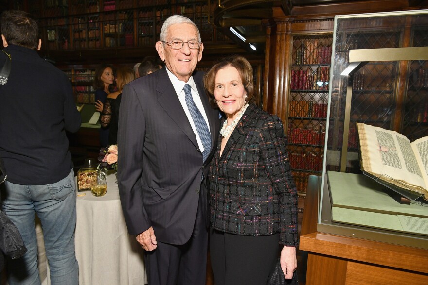 Eli Broad and his wife Edythe stand with their arms around each other at a 2017 dinner in New York.