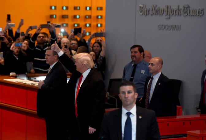 US President-elect  Donald Trump  waves to the crowd after leaving a meeting at the New York Times on November 22, 2016 in New York.
US President-elect Trump said Tuesday he has an open-mind about pulling out of world climate accords and admitted global warming may be in some way linked to human activity."I think there is some connectivity. Some, something. It depends on how much," he told a panel of New York Times journalists. 
 / AFP / TIMOTHY A. CLARY        (Photo credit should read TIMOTHY A. CLARY/AFP/Getty Images)