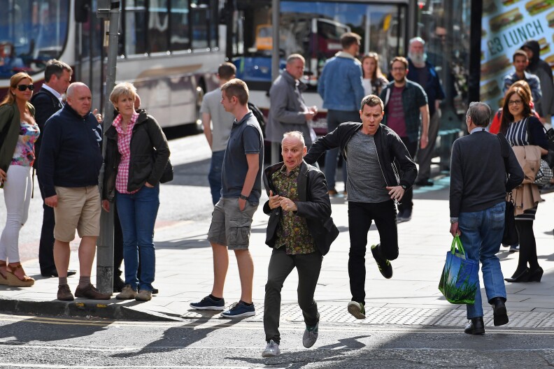 EDINBURGH, SCOTLAND - JULY 13:  Actors Ewan McGregor and Ewan Bremner run on the set of the Trainspotting film sequel on Princess Street on July 13, 2016 in Edinburgh, Scotland. The long awaited Trainspotting 2 is being filmed in Edinburgh and Glasgow, 20 years after the original was released and it will also see the cast from the first film returning including Ewan McGregor, Jonny Lee Miller and Robert Carlyle.  (Photo by Jeff J Mitchell/Getty Images)
