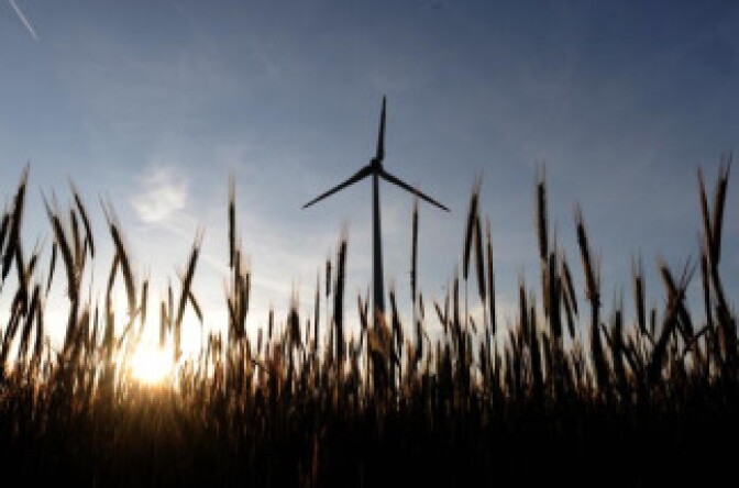 A wind turbine rises above field near the Austrian-Slovakian border during late afternoon on May 20, 2009.
