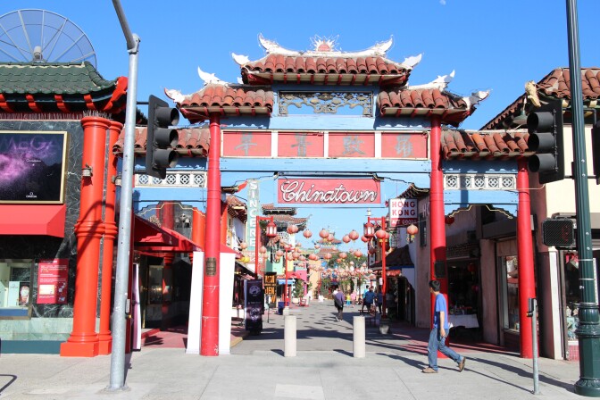 A pedestrian walks past the iconic entrance to Chinatown in downtown Los Angeles.