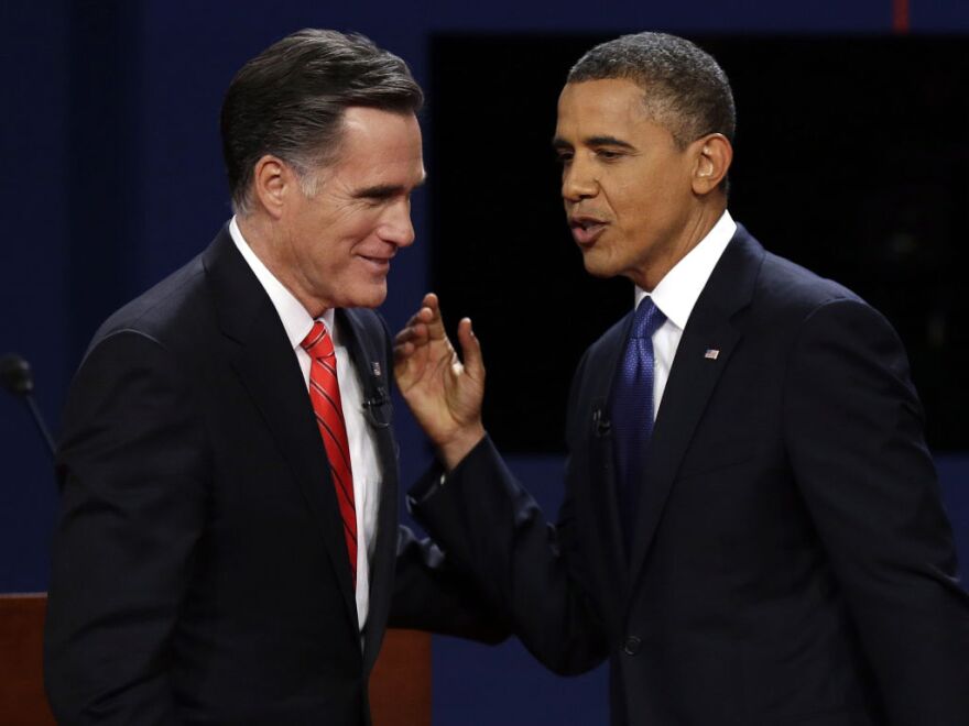 Republican presidential nominee Mitt Romney and President Obama talk after the first presidential debate at the University of Denver on Wednesday, Oct. 3, 2012.
