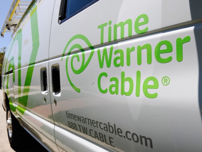 Time Warner Cable and CBS Corp. released upbeat earnings reports for the second quarter. A Friday deadline faces the two companies in their dispute over cable carriage fees. (File Photo: A Time Warner Cable van parked on the street on August 3, 2011 in Los Angeles).