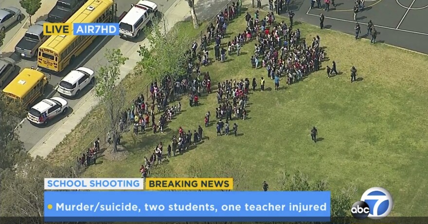 In this frame from video provided by KABC-TV, faculty and students evacuate North Park School Elementary School as emergency personnel respond to a shooting inside on Monday, April 10, 2017, in San Bernardino.