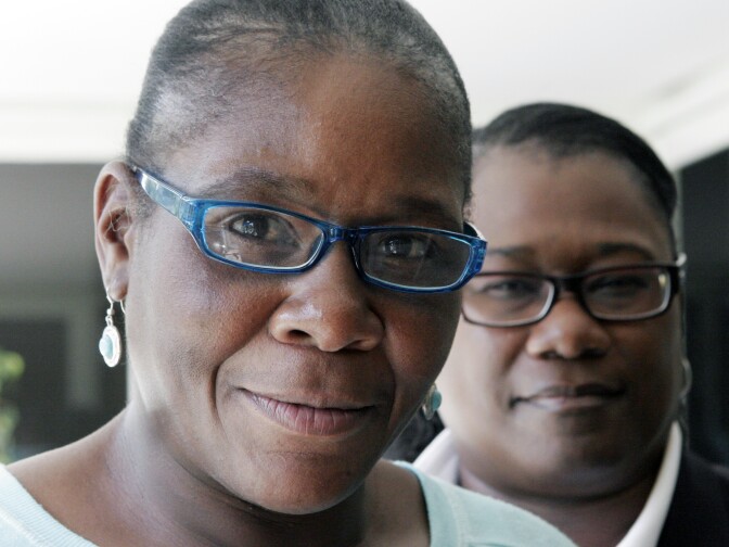 Marlene Pinnock, left, poses with her attorney, Caree Harper during an interview Sunday Aug. 10, 2014 in Los Angeles. Pinnock, a homeless woman was beaten by a CHP officer in July 2014. Sunday was Pinnock's first publicized interview since the incident, that was videotaped. (AP Photo/John Hopper)