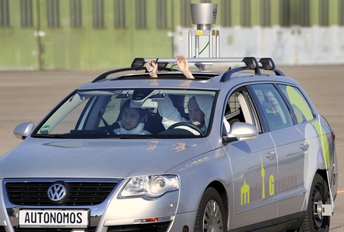 The driverless car "Made in Germany" (MIG), which from the outside looks like a regular Volkswagen Passat with a camera on top, is being put through its paces at Berlin's disused Tempelhof airport,