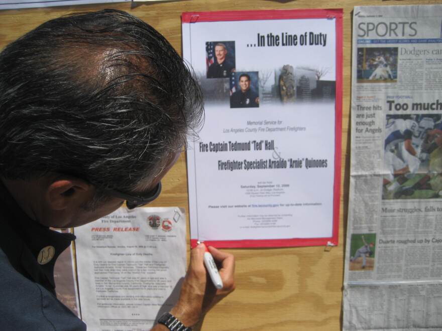 Carlos Guerrero of the Glendale Fire Department posts notice of Memorial Service for firefighters Ted Hall and Arnie Quinones.