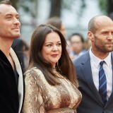British actors Jude Law (L), US actress Melissa McCarthy (C), and British actor Jason Statham pose for photographs on the carpet as they arrive to attend the European premiere of the film 'Spy' in London on May 27, 2015.   AFP PHOTO / NIKLAS HALLE'N        (Photo credit should read NIKLAS HALLE'N/AFP/Getty Images)