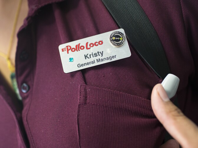 General Manager Kristy Ramirez decorated her name tag she recently received when she was promoted at one of Michaela Mendelsohn's six El Pollo Loco franchises she owns in Southern California on Wednesday afternoon, July 14, 2016.