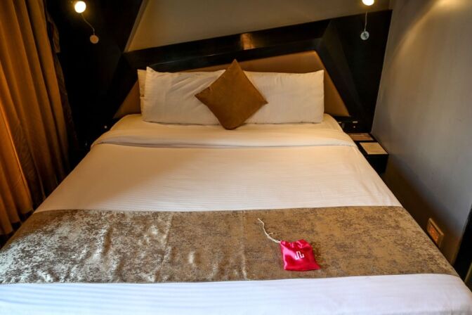 In this photo taken on February 10, 2020 a 'love kit' is seen on the bed in a room at the Dragonfly hotel in Mumbai. - Check in by the hour, bring your special someone, and help yourself to complimentary condoms -- Indian apps are overturning traditional norms by offering rooms to unmarried couples in a country where premarital sex remains taboo. (Photo by Punit PARANJPE / AFP) / TO GO WITH 'India-economy-techonolgy-romance-hotels - FOCUS, by Ammu KANNAMPILLY (Photo by PUNIT PARANJPE/AFP via Getty Images)