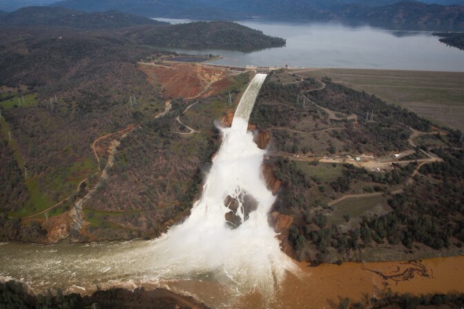 Lake Oroville, the emergency spillway, and the damaged main spillway, are seen from the air on Feb. 13, 2017 in Oroville, California.